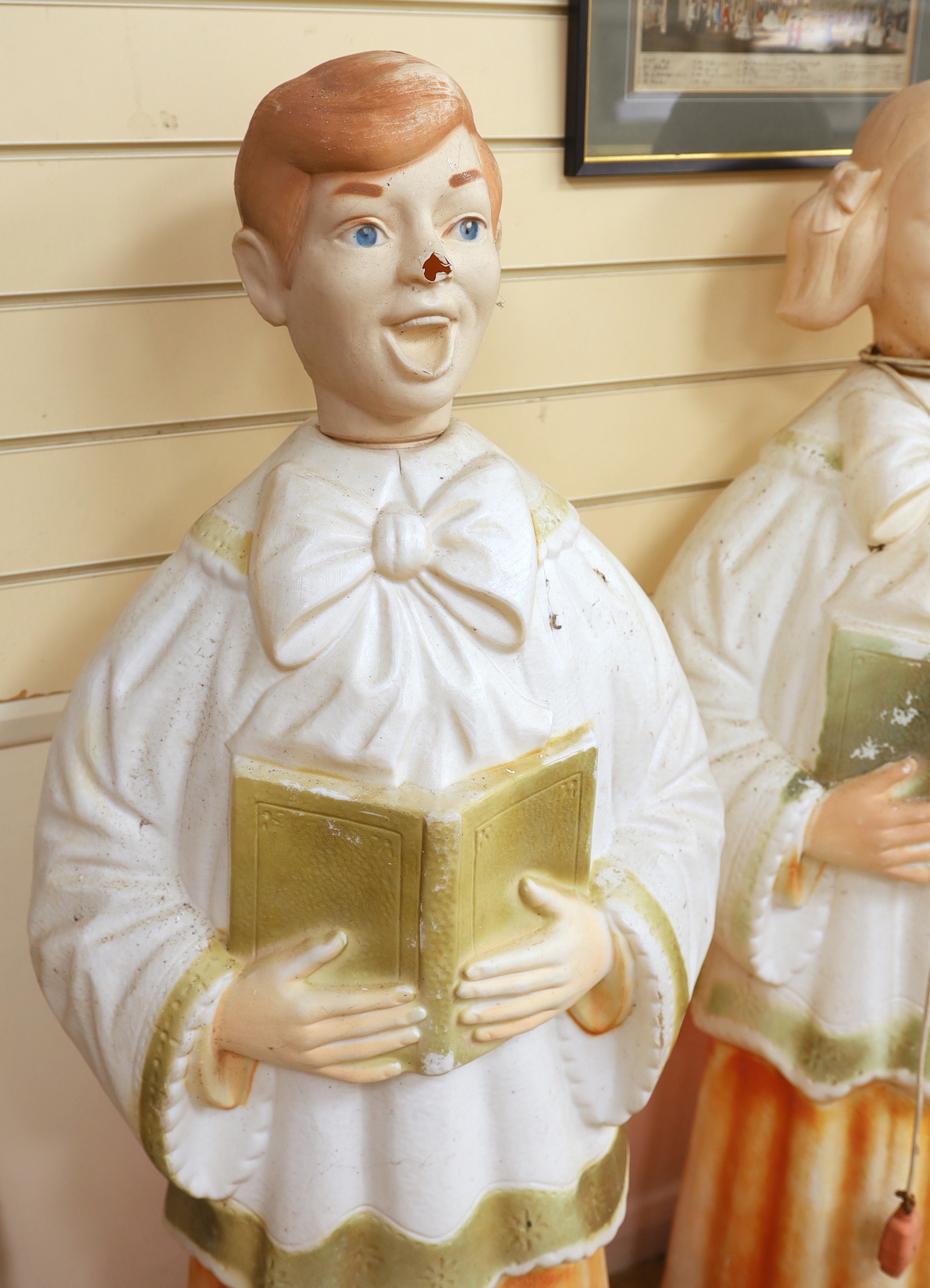 A pair of mid century celluloid illuminating choristers, approximately 127cm high